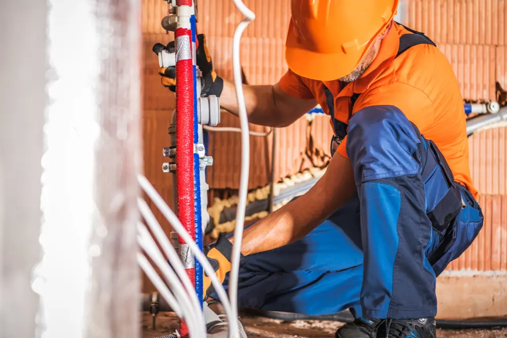 Plumber installing new piping system in a commercial building in North Bay