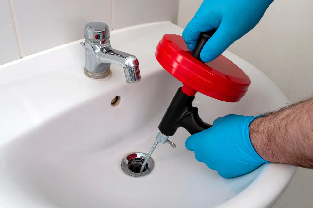 Poly-B technician installing a backflow prevention device and performing a compliance test in Orillia
