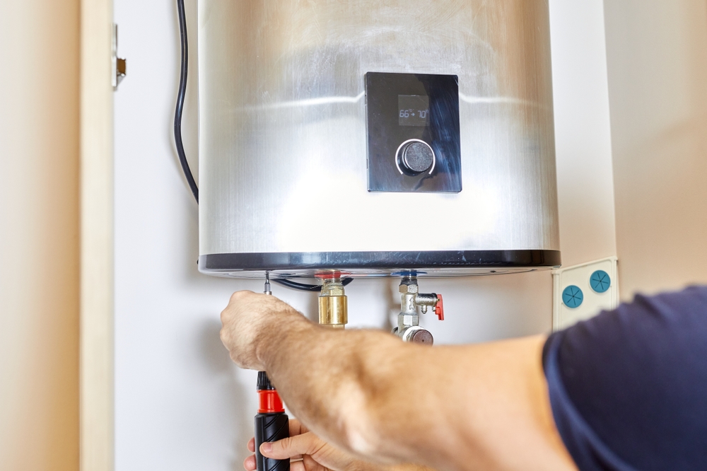 Side-by-side comparison of a traditional tank water heater and a wall-mounted tankless unit