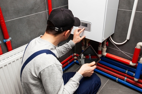 Licensed plumber installing a variety of plumbing components including sinks, toilets, pumps, and water heaters