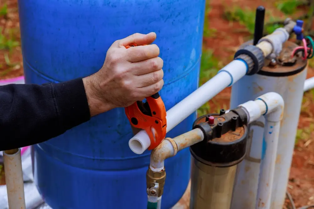 Licensed plumber installing various fixtures like sinks, toilets, and water heaters at a job site