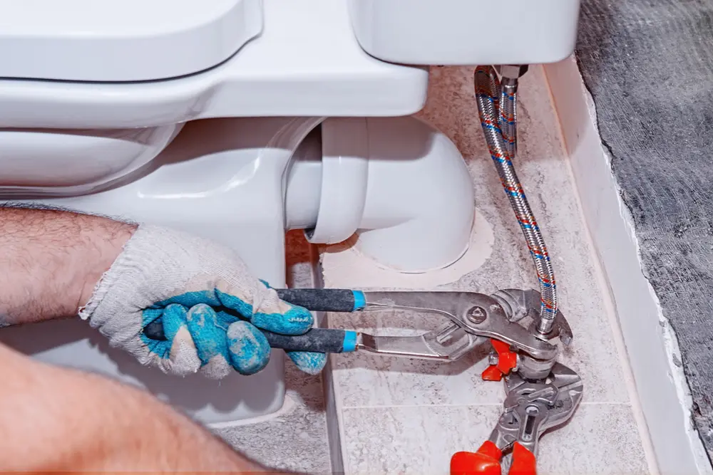 Professional plumber providing plumbing services in a residential home in Corbeil, ON