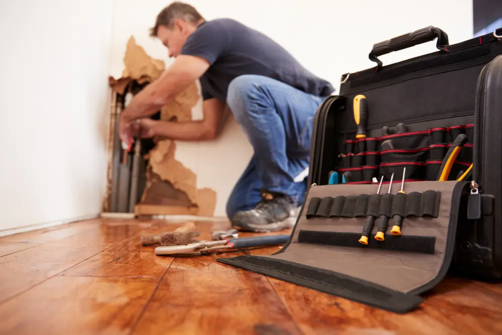 Plumber working on renovation plumbing at a commercial site in Orillia or North Bay