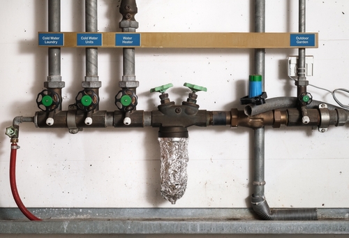 Diagram showing how backflow can allow contaminated water to enter a clean water supply line