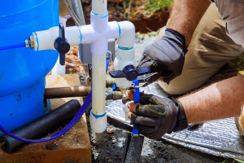Close-up of a submersible well pump being prepared for installation at a rural or commercial site.
