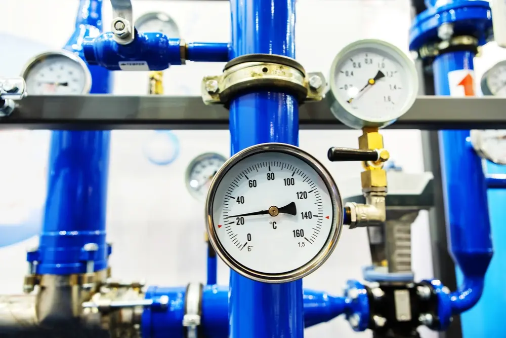 Concerned homeowner noticing weak water flow, signaling the need for a plumbing pressure test